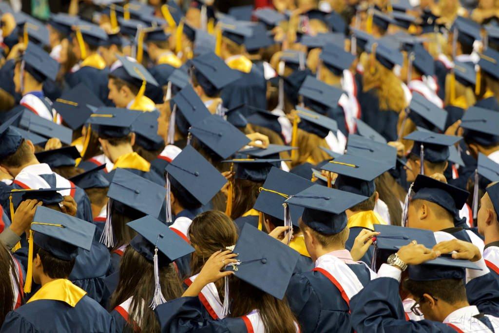 new graduates in caps and gowns
