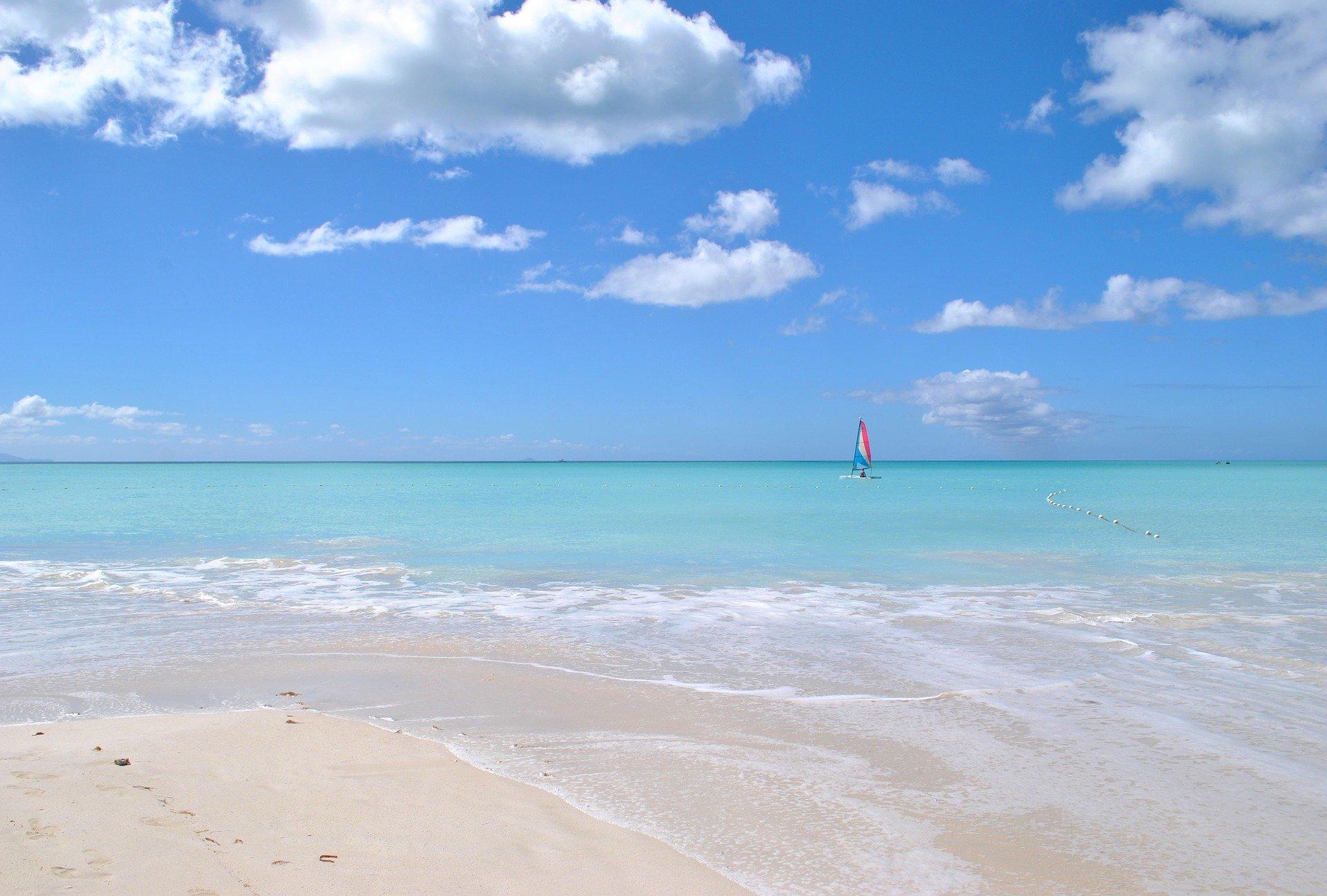 Dreaming of Antigua and Barbuda Travel for Your Family Vacation - single boat sailing in tropical waters