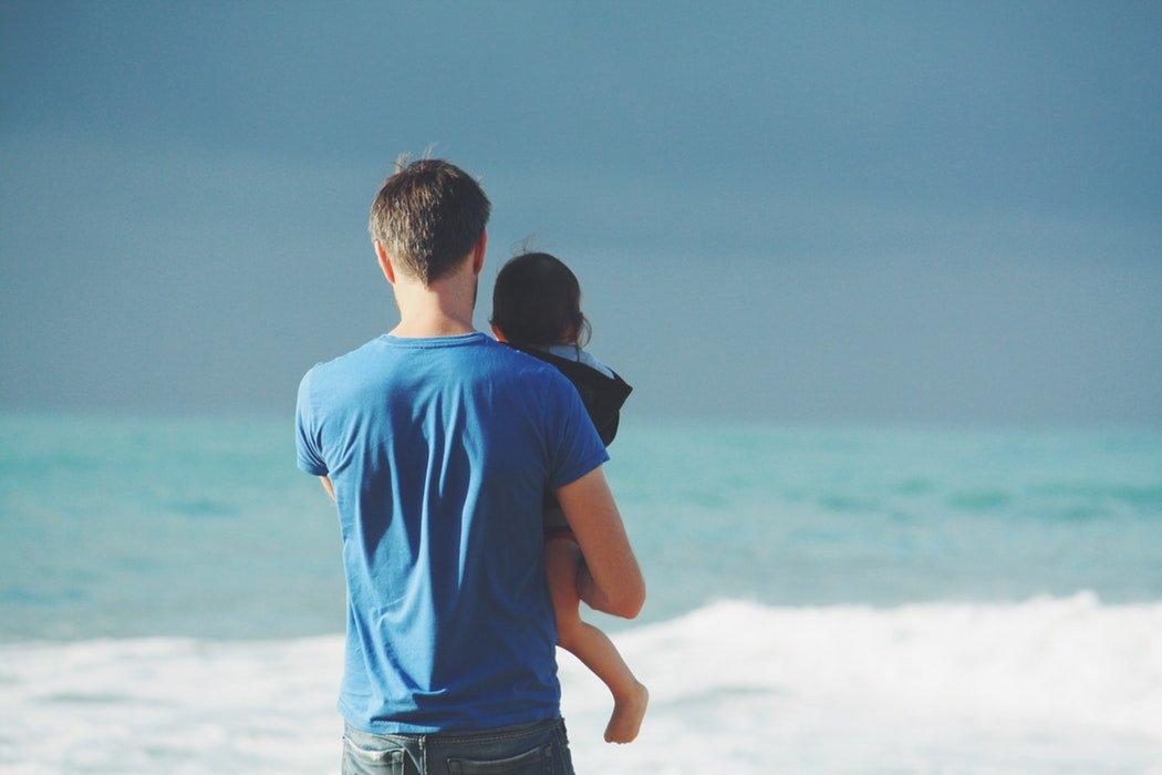 Father's Day Vacation Ideas: Create Memories with Family - Father Holding Child While Near the Ocean