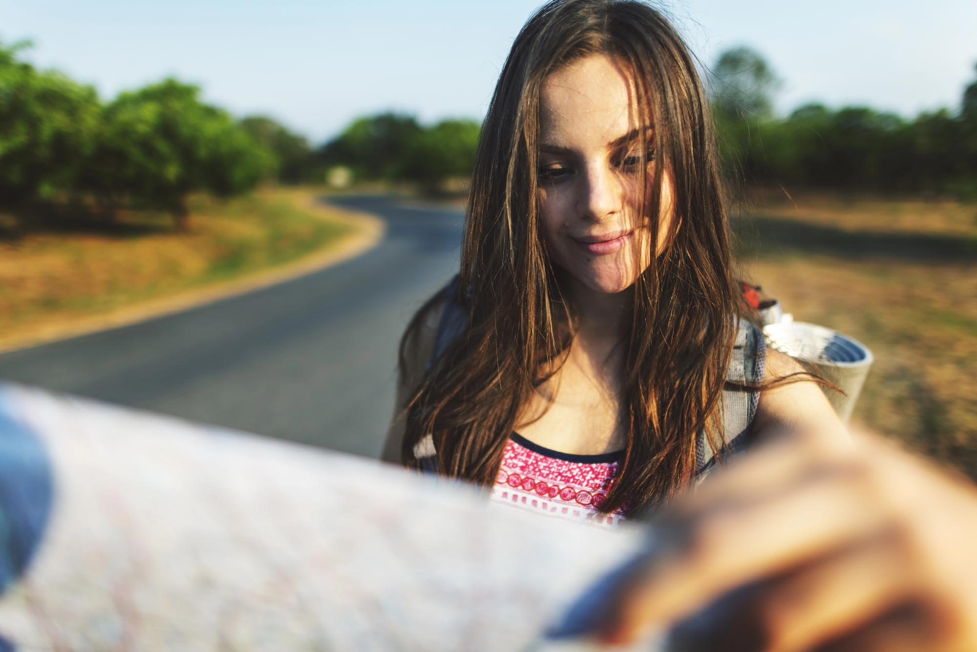 Reasons Solo Female Travelers Should Embrace Vacations - Solo Female Traveler Looking at a Map